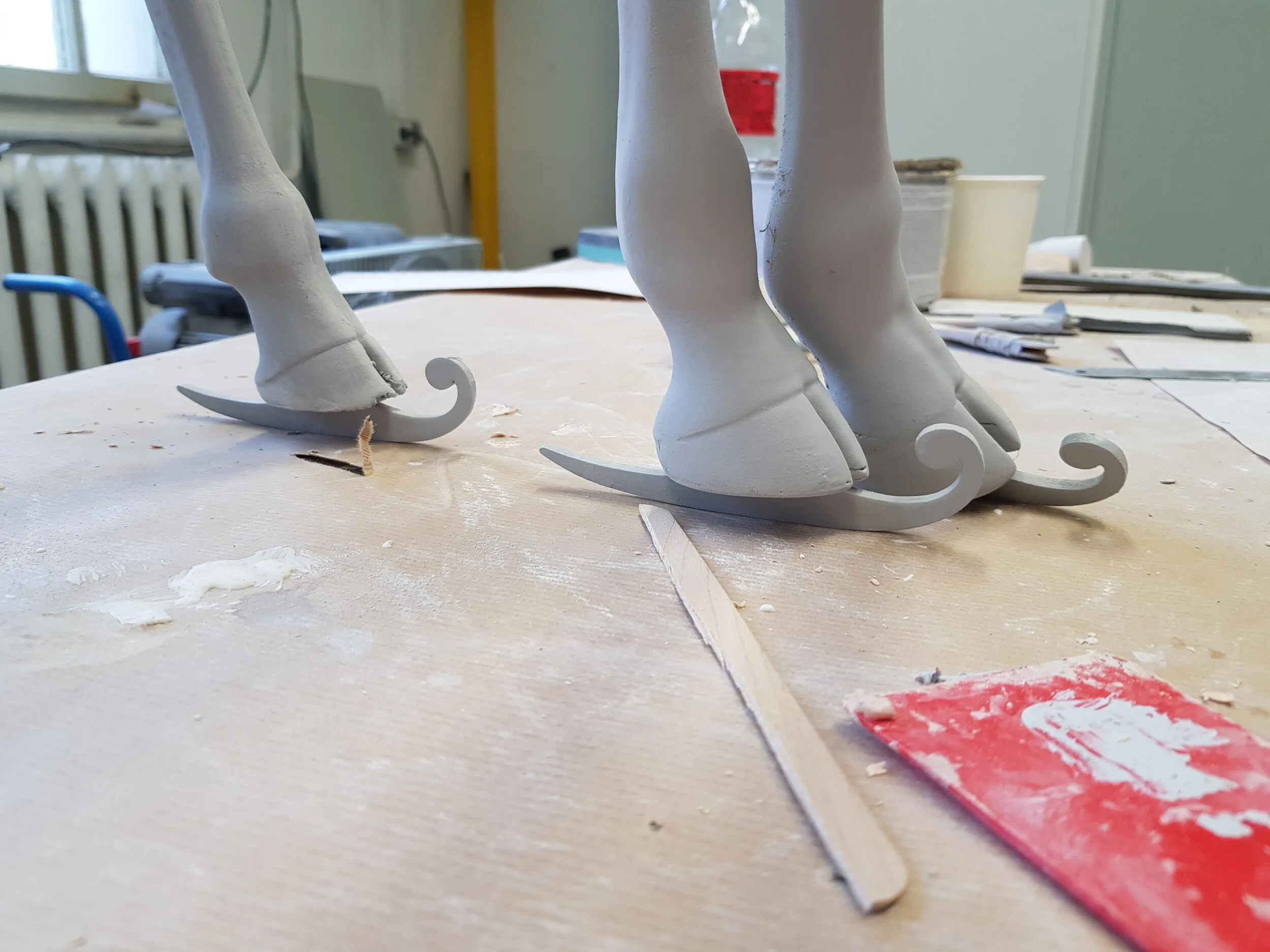 Large-format giraffe figure being prepared for finishing.