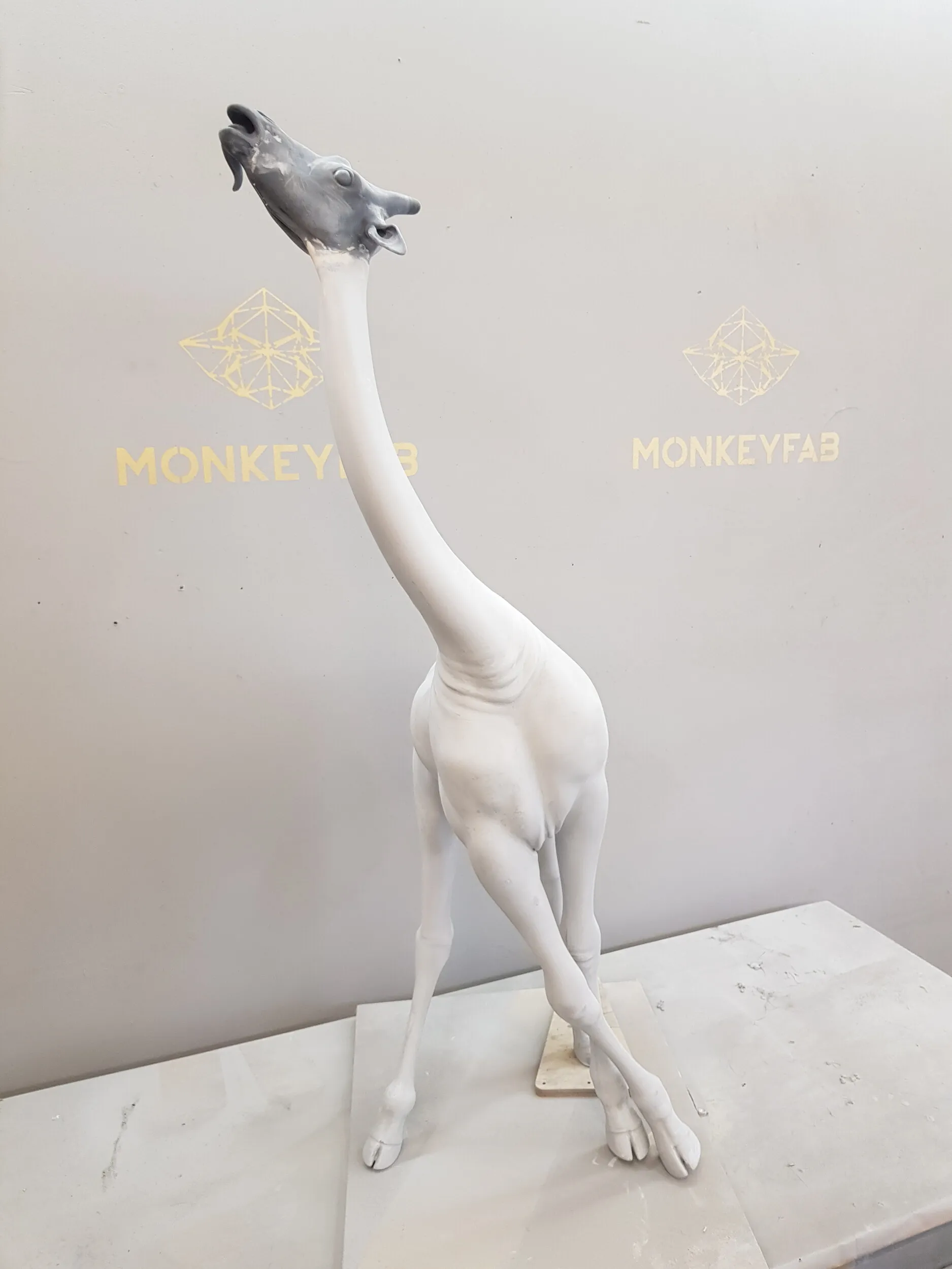 Unpainted 3D-printed skating giraffe figure.